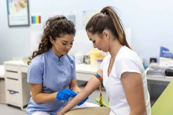 A nurse drawing blood from a patient for a lab test