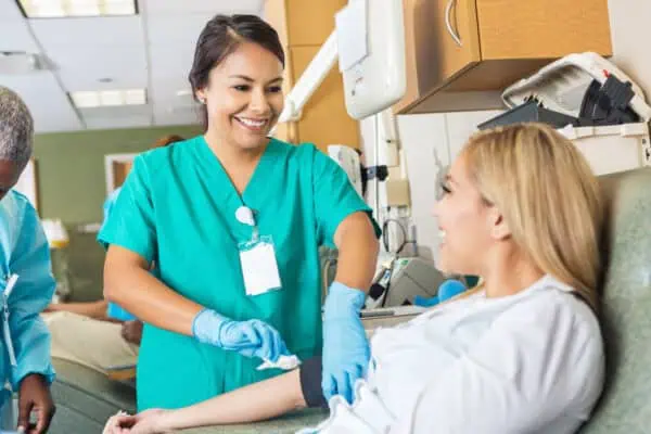 A nurse drawing blood from a patient for a lab test